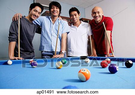 Men standing around pool table, looking at camera View Large Photo Image Stock Image - Men standing around pool table, looking at camera. Fotosearch