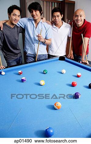 Men standing around pool table View Large Photo Image Stock Image - Men standing around pool table. Fotosearch