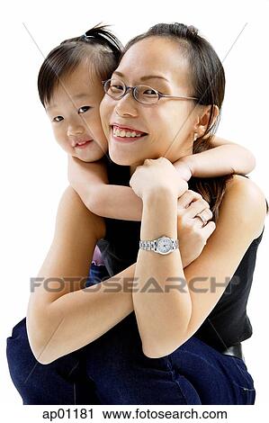 Mother and daughter embracing, smiling at camera View Large Photo Image Stock Image - Mother and daughter embracing, smiling at camera. Fotosearch