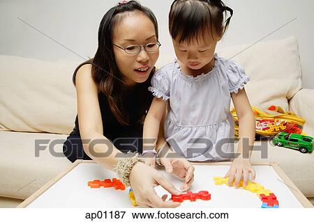 Mother and daughter, playing with toys View Large Photo Image Stock Photo - Mother and daughter, playing with toys. Fotosearch
