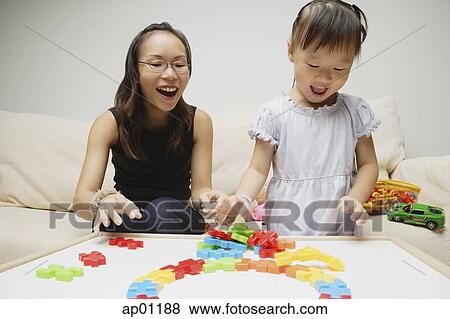 Mother and daughter, playing with toys, smiling View Large Photo Image Stock Photo - Mother and daughter, playing with toys, smiling. Fotosearch