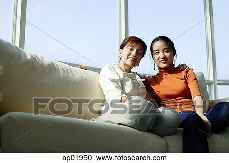 Mother and daughter sitting side by side View Large Photo Image Stock Image - Mother and daughter sitting side by side. Fotosearch