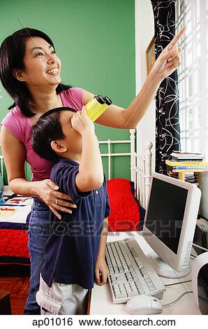 Mother and son standing side by side, son using binoculars, mother pointing at window View Large Photo Image Stock Photograph - Mother and son standing side by side, son using binoculars, mother pointing at window. Fotosearch