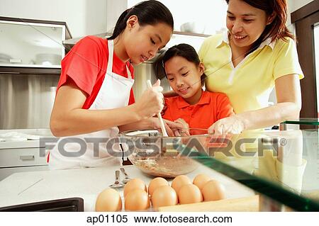 Mother and two daughters in kitchen View Large Photo Image Stock Photography - Mother and two daughters in kitchen. Fotosearch