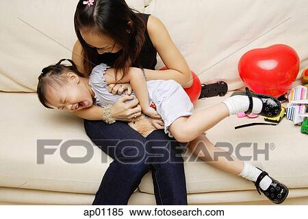 Mother tickling daughter View Large Photo Image Stock Photography - Mother tickling daughter. Fotosearch