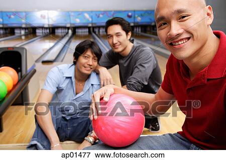 Three men in bowling alley, looking at camera View Large Photo Image Stock Photo - Three men in bowling alley, looking at camera. Fotosearch