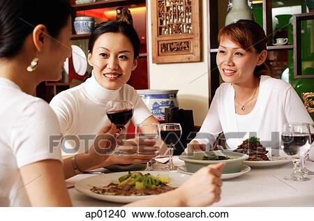 Three women dining out View Large Photo Image Stock Image - Three women dining out. Fotosearch