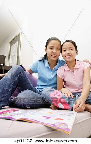 Two sisters looking at camera View Large Photo Image Stock Photo - Two sisters looking at camera. Fotosearch
