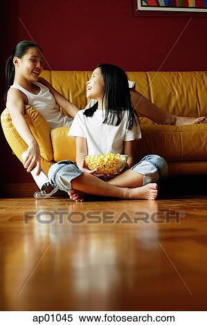 Two sisters sitting in living room, talking View Large Photo Image Stock Photography - Two sisters sitting in living room, talking. Fotosearch