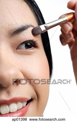 Woman applying eyeshadow, close-up View Large Photo Image Stock Photo - Woman applying eyeshadow, close-up. Fotosearch