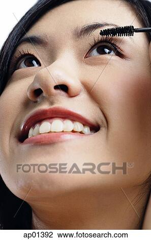 Stock Image - Woman applying mascara. Fotosearch