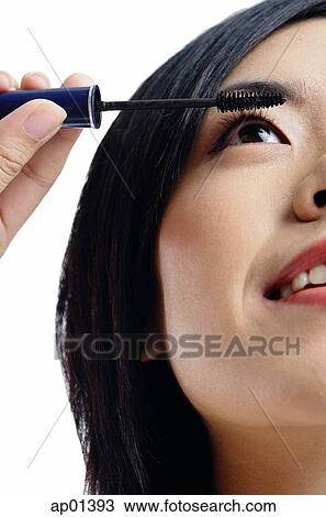 Stock Image - Woman applying mascara. Fotosearch