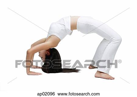 Stock Photograph - Woman doing yoga, bridge position. Fotosearch