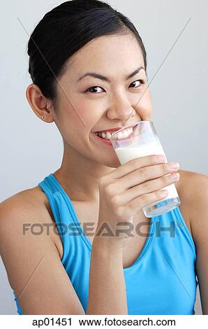 Stock Image - Woman drinking glass of milk. Fotosearch