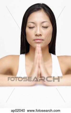Woman eyes closed, hands together View Large Photo Image Stock Image - Woman eyes closed, hands together. Fotosearch