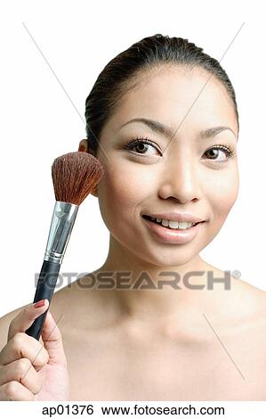 Woman holding make-up brush View Large Photo Image Stock Photograph - Woman holding make-up brush. Fotosearch