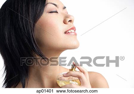 Woman holding perfume bottle View Large Photo Image Stock Image - Woman holding perfume bottle. Fotosearch
