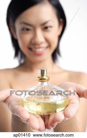 Woman holding perfume bottle View Large Photo Image Stock Image - Woman holding perfume bottle. Fotosearch