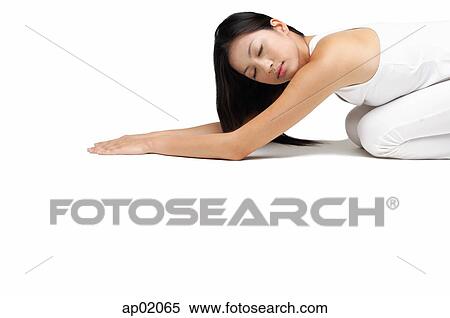 Stock Photography - Woman kneeling on floor. Fotosearch