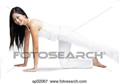 Woman kneeling on floor, stretching leg, smiling at camera View Large Photo Image Stock Photo - Woman kneeling on floor, stretching leg, smiling at camera. Fotosearch