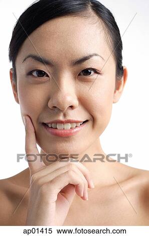 Woman looking at camera, hand on chin View Large Photo Image Stock Photography - Woman looking at camera, hand on chin. Fotosearch