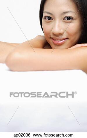 Stock Photograph - Woman looking at camera, smiling. Fotosearch