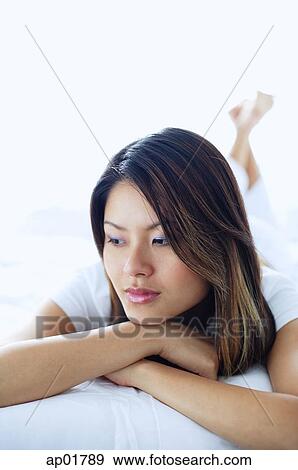 Woman looking away, lying on front, arms crossed View Large Photo Image Stock Photo - Woman looking away, lying on front, arms crossed. Fotosearch