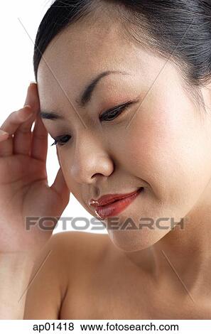 Woman looking down, hand on head View Large Photo Image Stock Photo - Woman looking down, hand on head. Fotosearch