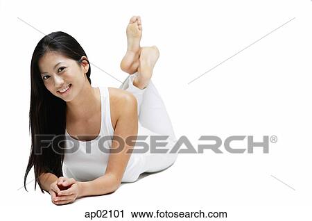 Woman lying on floor, legs crossed at the ankle, smiling at camera View Large Photo Image Stock Image - Woman lying on floor, legs crossed at the ankle, smiling at camera. Fotosearch