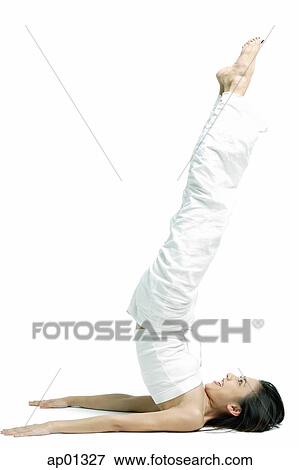 Woman lying on floor, raising legs in air View Large Photo Image Stock Photo - Woman lying on floor, raising legs in air. Fotosearch