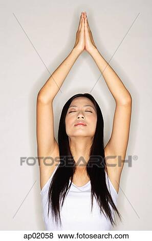 Woman practicing yoga, arms outstretched, eyes closed View Large Photo Image Stock Photo - Woman practicing yoga, arms outstretched, eyes closed. Fotosearch