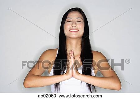 Woman practicing yoga, hands together, eyes closed, smiling View Large Photo Image Stock Image - Woman practicing yoga, hands together, eyes closed, smiling. Fotosearch
