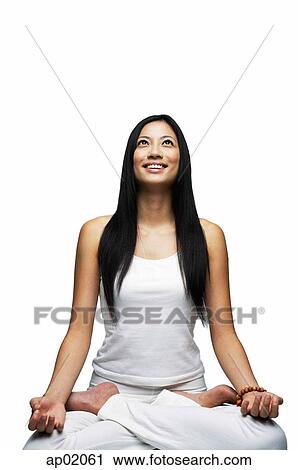 Woman practicing yoga, sitting in lotus position, smiling View Large Photo Image Stock Image - Woman practicing yoga, sitting in lotus position, smiling. Fotosearch