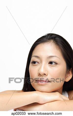 Woman resting hand on chin, looking away View Large Photo Image Stock Image - Woman resting hand on chin, looking away. Fotosearch