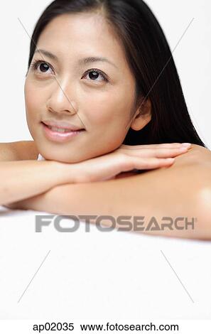 Woman resting head on arms, smiling View Large Photo Image Stock Photography - Woman resting head on arms, smiling. Fotosearch