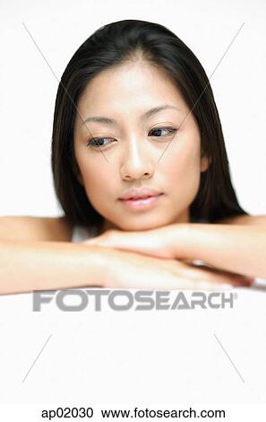 Woman resting head on hands, with downwards glance View Large Photo Image Stock Image - Woman resting head on hands, with downwards glance. Fotosearch