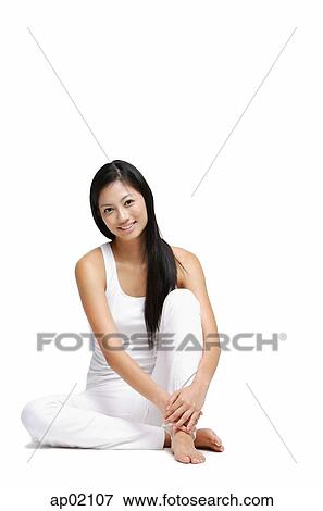 Woman sitting on floor, hugging knee, looking at camera View Large Photo Image Stock Photo - Woman sitting on floor, hugging knee, looking at camera. Fotosearch