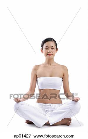 Woman sitting on floor, legs crossed, eyes closed View Large Photo Image Stock Photo - Woman sitting on floor, legs crossed, eyes closed. Fotosearch