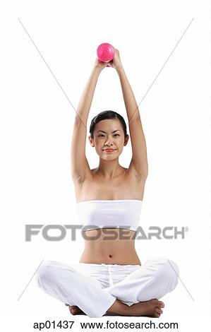 Woman sitting on floor, lifting dumbbells, looking at camera View Large Photo Image Stock Photo - Woman sitting on floor, lifting dumbbells, looking at camera. Fotosearch