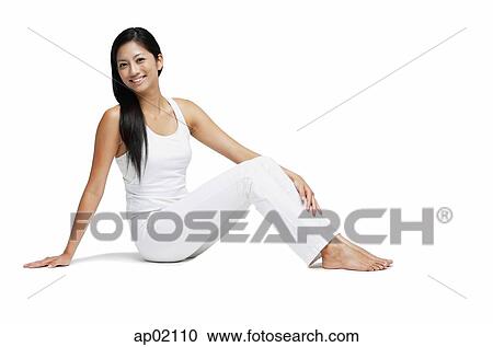 Woman sitting on floor, looking at camera, legs outstretched View Large Photo Image Stock Image - Woman sitting on floor, looking at camera, legs outstretched. Fotosearch