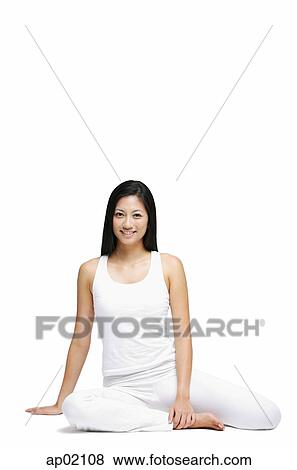 Stock Photo - Woman sitting on floor, looking at camera. Fotosearch