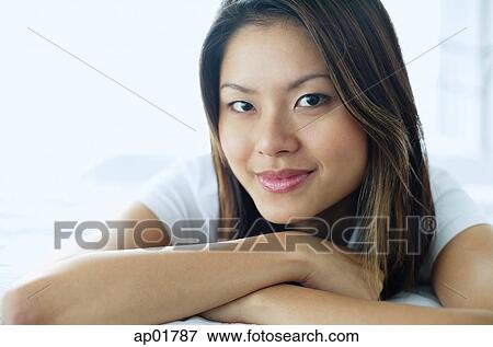 Woman smiling at camera, arms crossed View Large Photo Image Stock Photo - Woman smiling at camera, arms crossed. Fotosearch