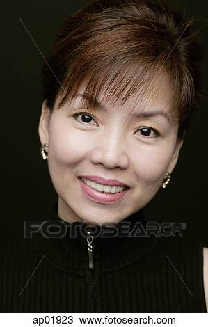 Woman smiling at camera, portrait View Large Photo Image Stock Image - Woman smiling at camera, portrait. Fotosearch