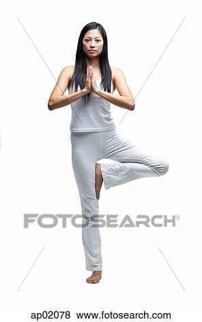 Stock Photo - Woman standing in yoga position. Fotosearch