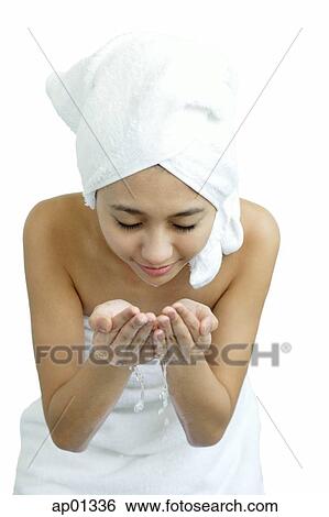 Woman washing her face, holding water in cupped hands View Large Photo Image Stock Photograph - Woman washing her face, holding water in cupped hands. Fotosearch