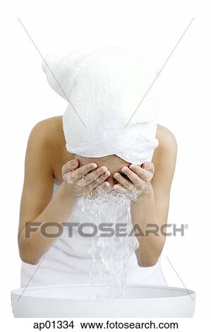 Woman washing her face View Large Photo Image Picture - Woman washing her face. Fotosearch