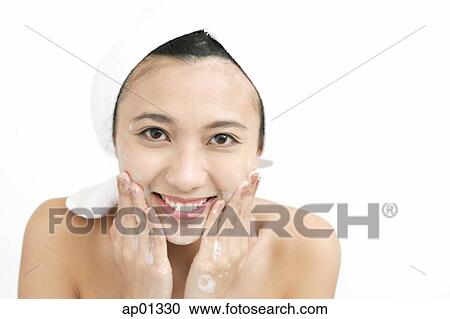 Woman washing her face, smiling at camera View Large Photo Image Stock Image - Woman washing her face, smiling at camera. Fotosearch