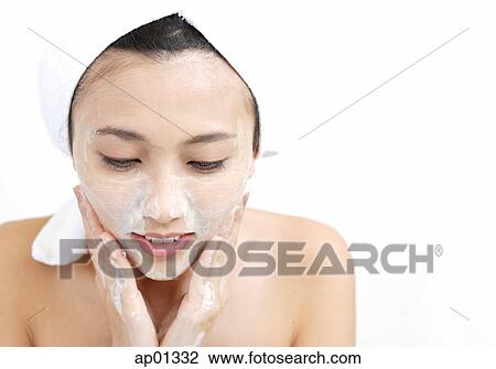 Stock Image - Woman washing her face. Fotosearch