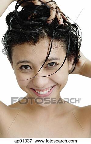 Stock Photo - Woman washing her hair, looking at camera. Fotosearch