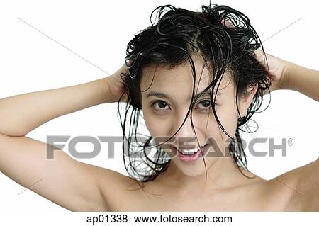 Stock Photo - Woman washing her hair, looking at camera. Fotosearch